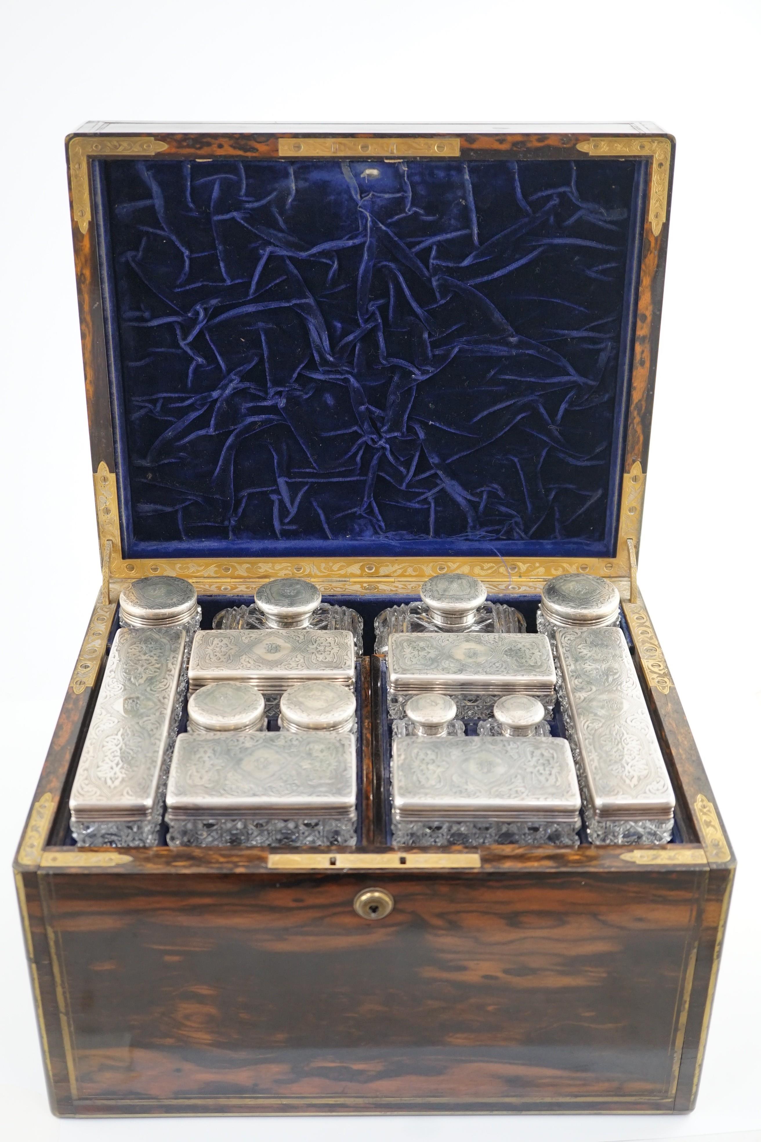 A Victorian brass mounted coromandel wood toilet box, containing fourteen engraved silver mounted toilet jars, by Thomas Whitehouse, London, 1865